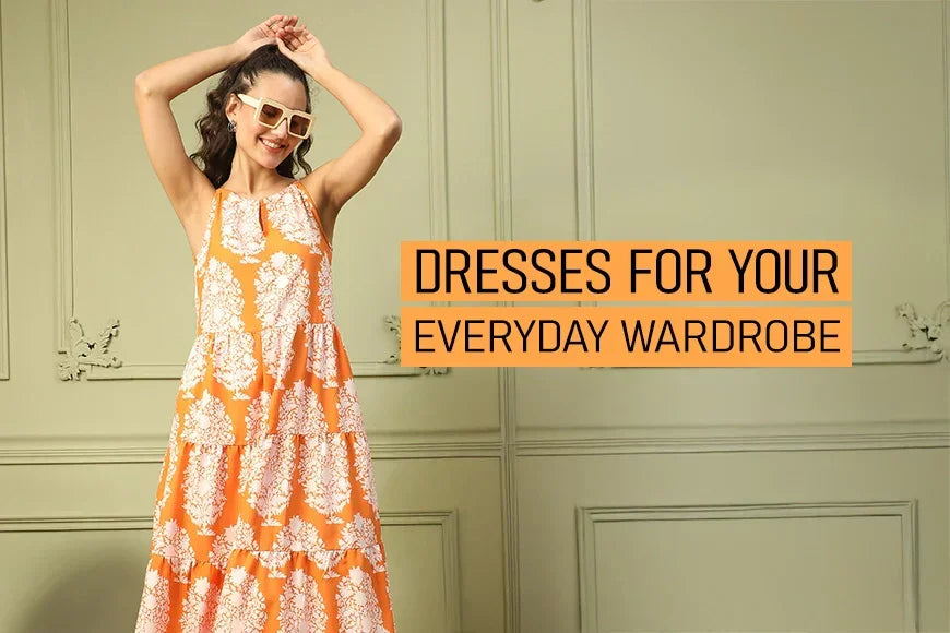 Woman in an orange floral sleeveless dress, wearing sunglasses, standing indoors with text 'Dresses for your everyday wardrobe'.