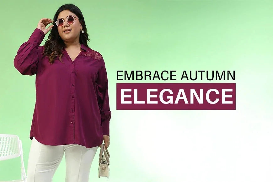 Plus size woman in purple blouse and white pants posing against pastel green background, autumn fashion