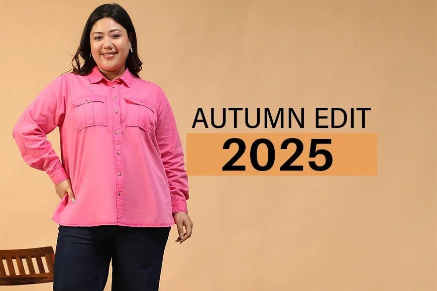 Plus size woman in pink button-up shirt and dark pants modeling autumn fashion 2025