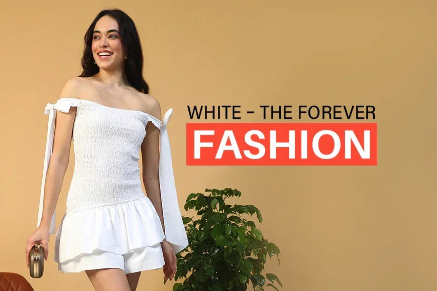 Woman in off-shoulder white dress, trendy summer fashion, standing indoors with a clutch