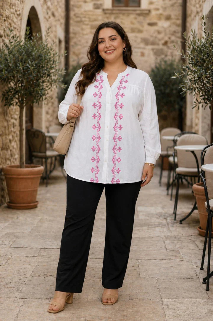 Smiling woman wearing a pink striped button-down shirt for plus size fashion