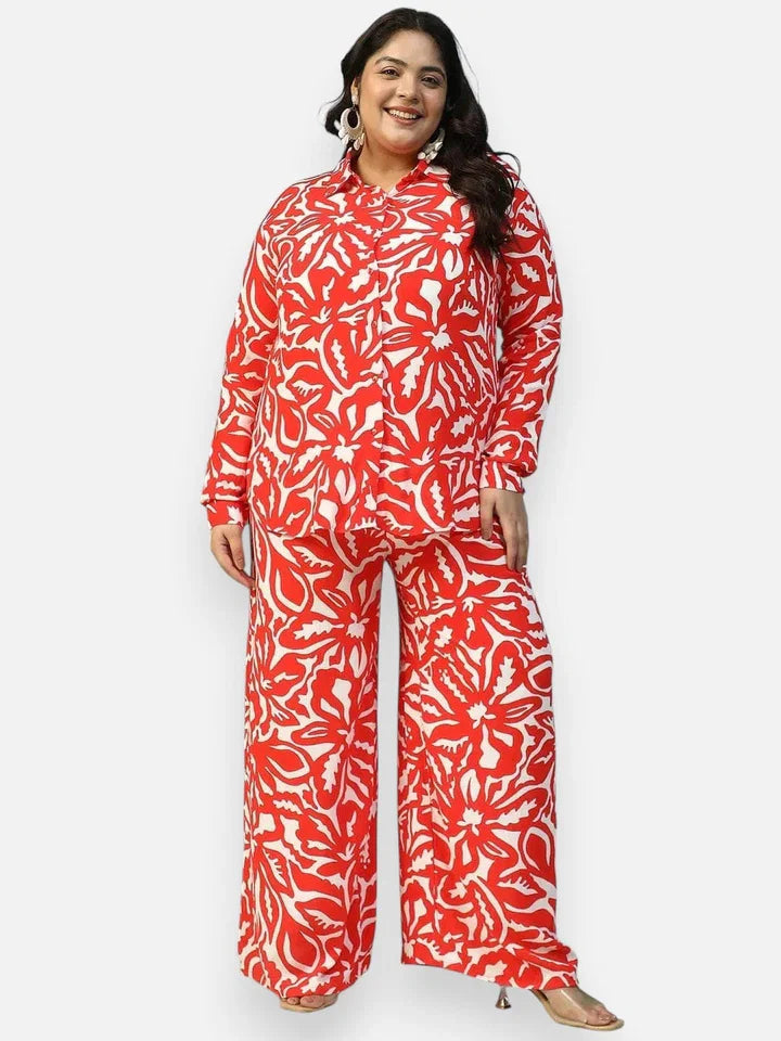 Plus size woman in red and white floral print co-ord set with long sleeve shirt and wide leg pants