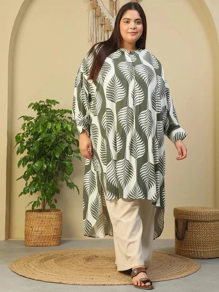 Plus size woman in loose fit checked tunic top and wide leg beige pants, front view
