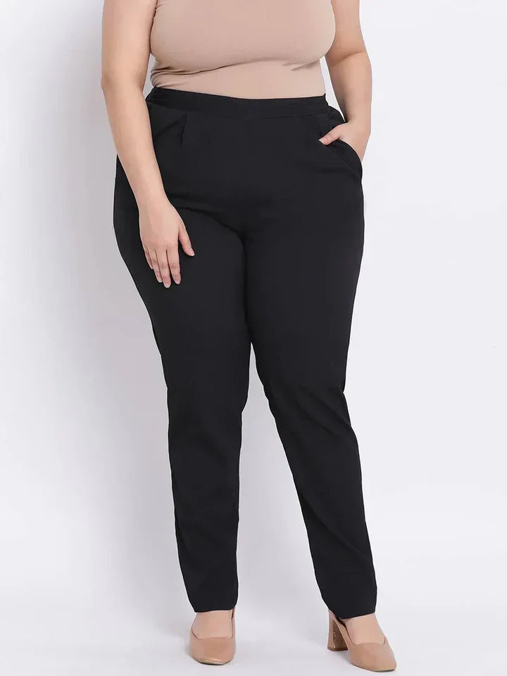 Plus size woman wearing black straight fit pants and nude heels, fashion clothing