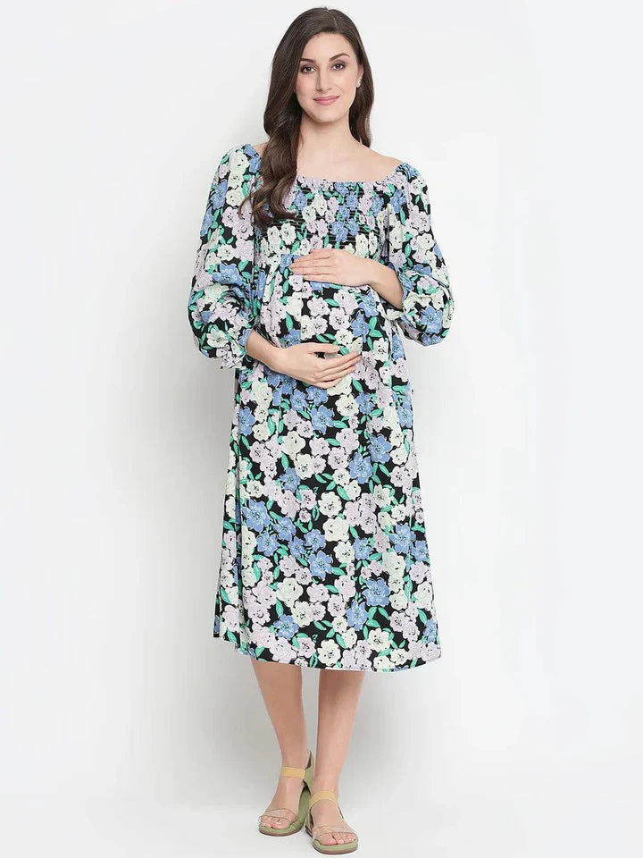 Woman wearing floral maternity dress with long sleeves and square neckline