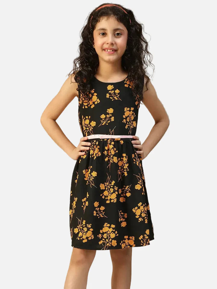 Girl wearing sleeveless black floral dress with yellow flower print and pink belt