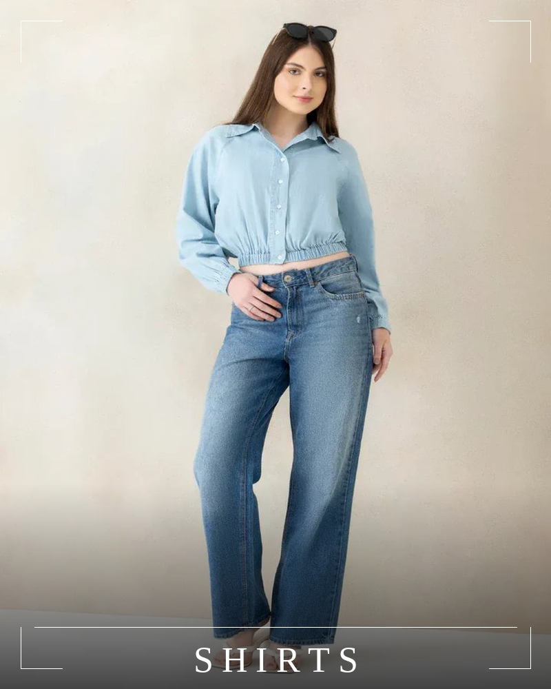 Woman wearing a colorful animal print button-down shirt with long sleeves and teal pants