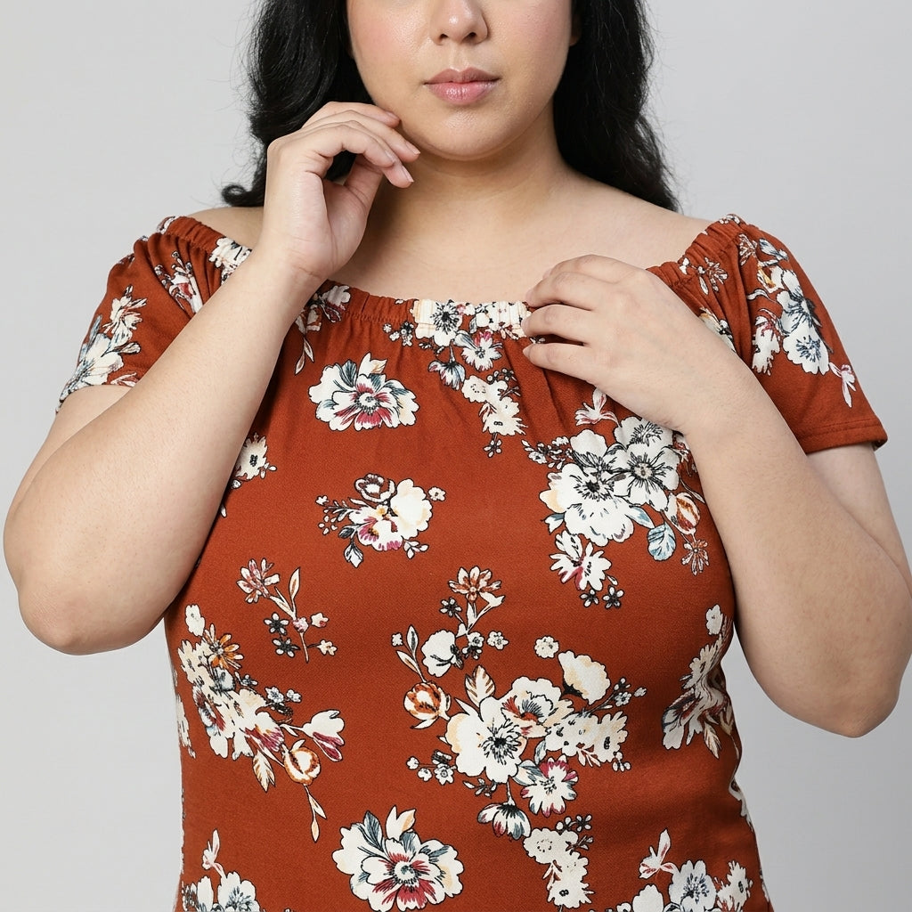 Plus size woman wearing off-shoulder brown floral top, trendy women's fashion clothing