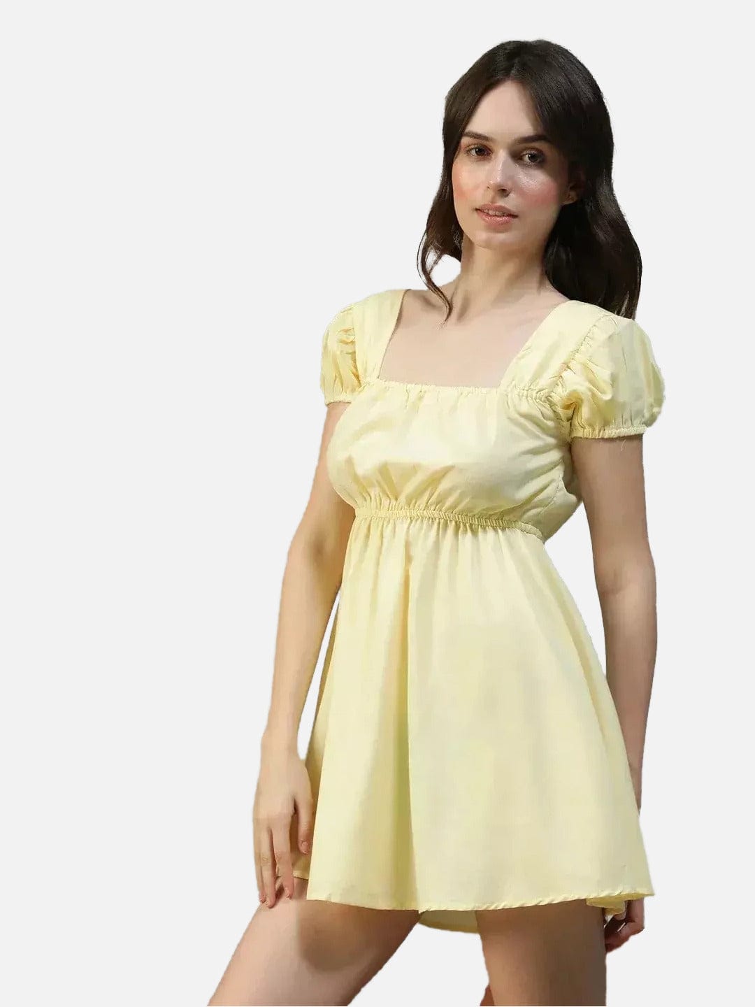 A woman wearing a yellow dress with puffed sleeves and a ruffled neckline, posing for a photograph.