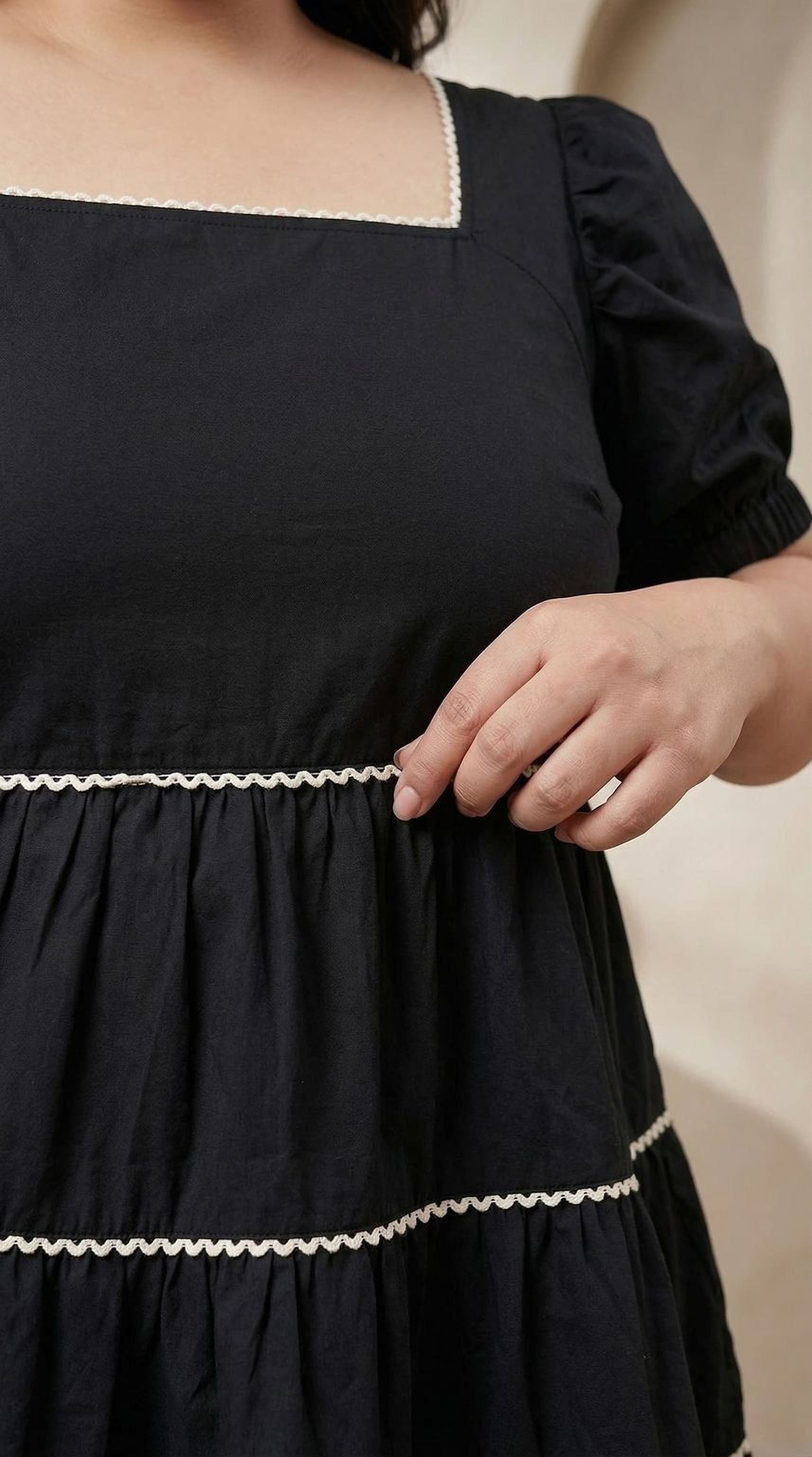 oxolloxo black cotton tiered dress with square neckline and puffed sleeves, accented with white piping