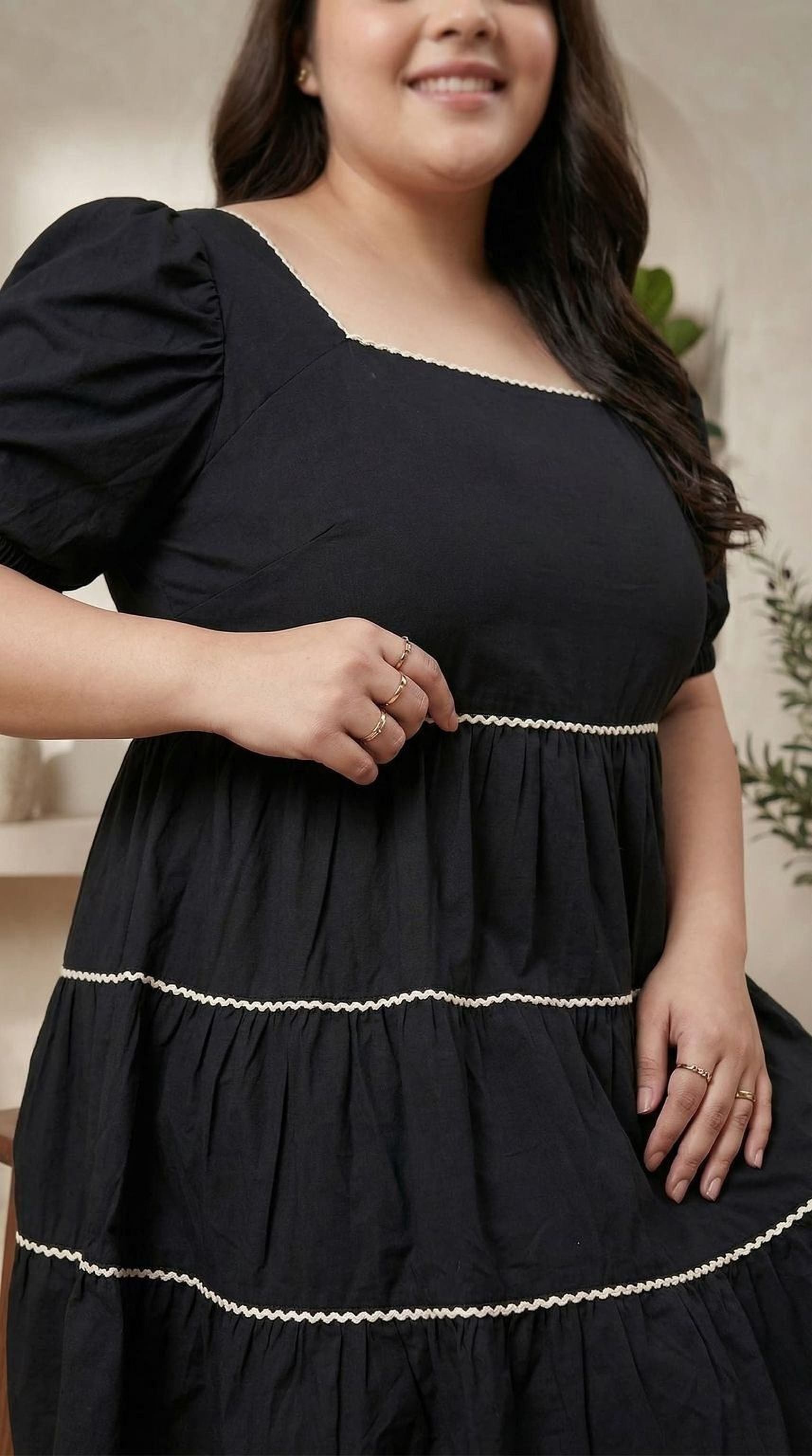 oxolloxo black cotton tiered midi dress with square neckline and puffed sleeves, accented with white piping.