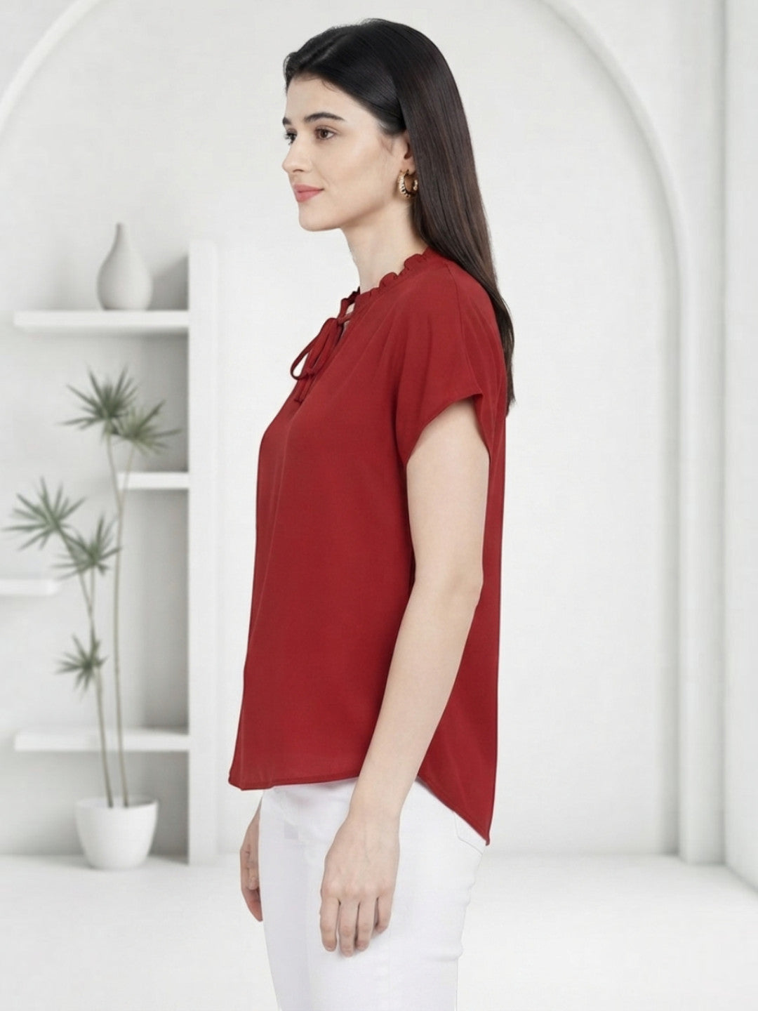 Red women's blouse with ruffled neckline and short sleeves, paired with white pants for casual wear