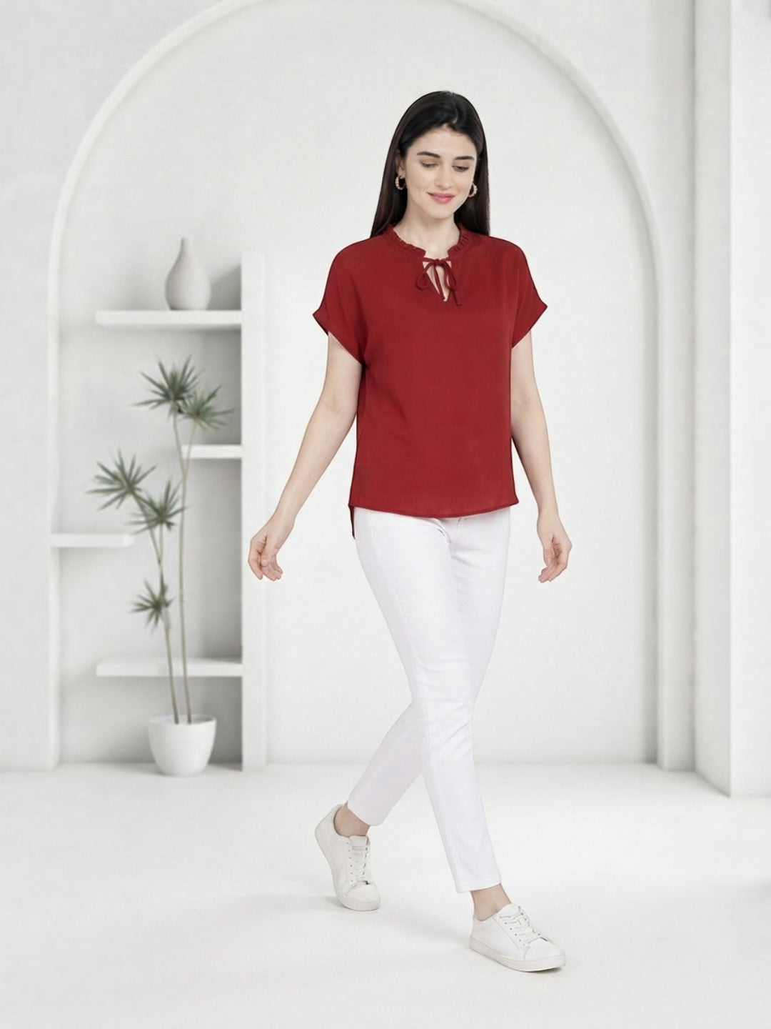 Woman in red tie-neck top and white pants, stylish plus size fashion outfit