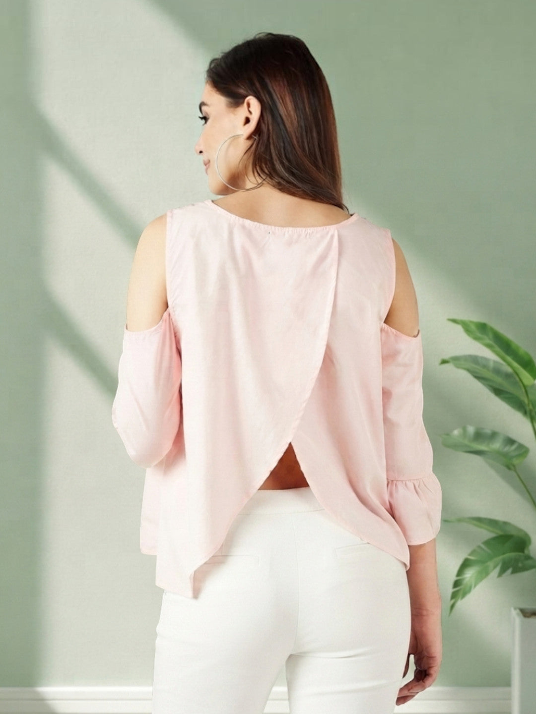 Pink cold shoulder blouse with back slit, paired with white pants for trendy women's fashion