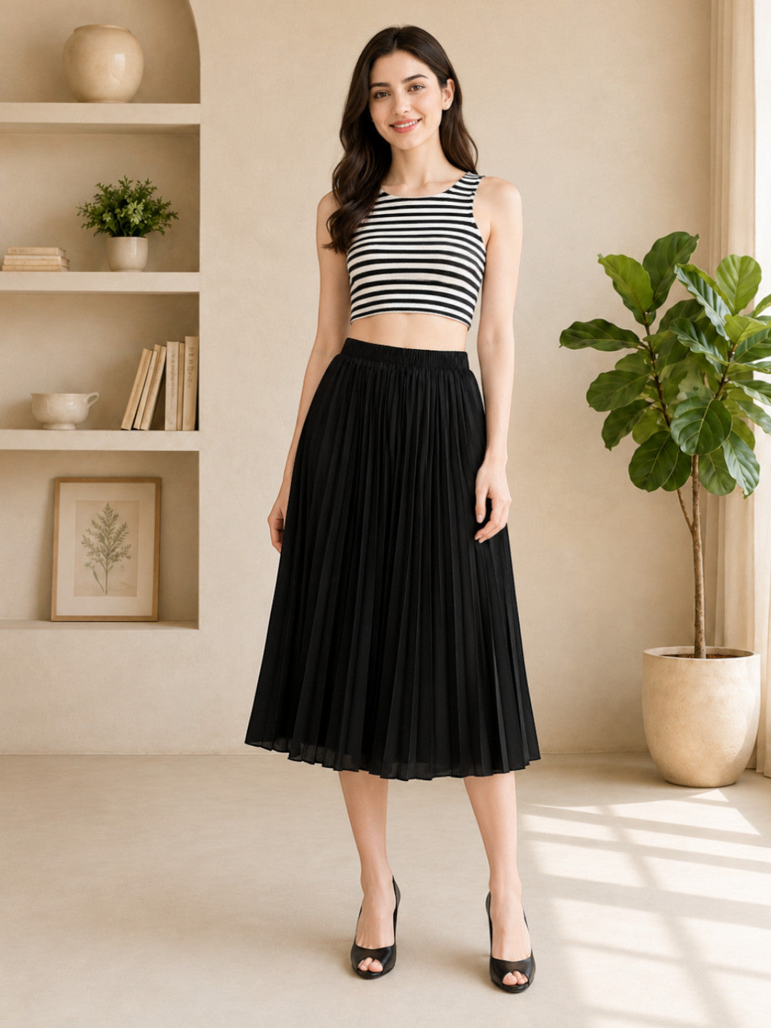 Black pleated midi skirt with striped crop top, stylish women's fashion outfit