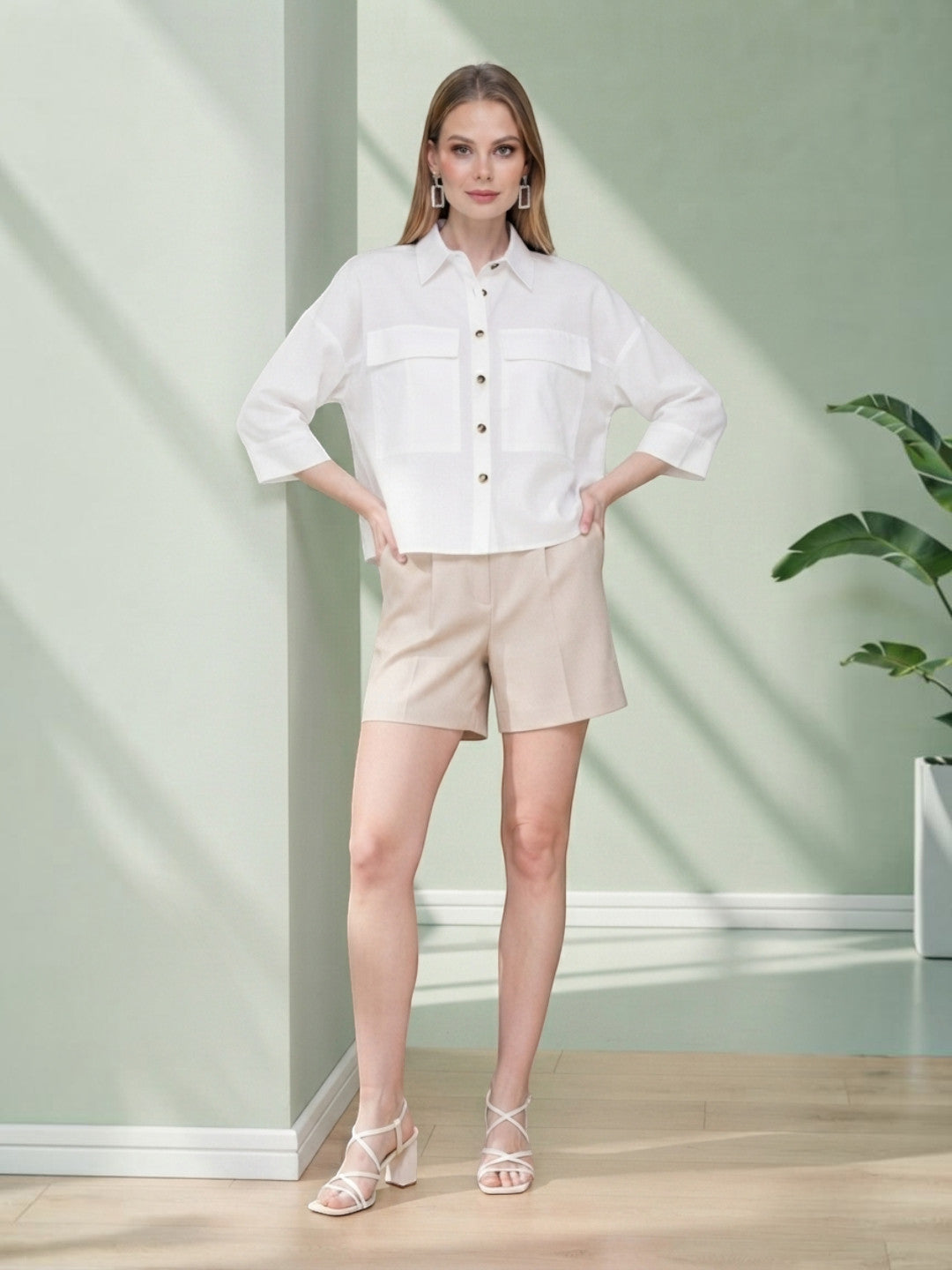White button-up shirt with beige shorts, stylish women's fashion outfit for casual wear