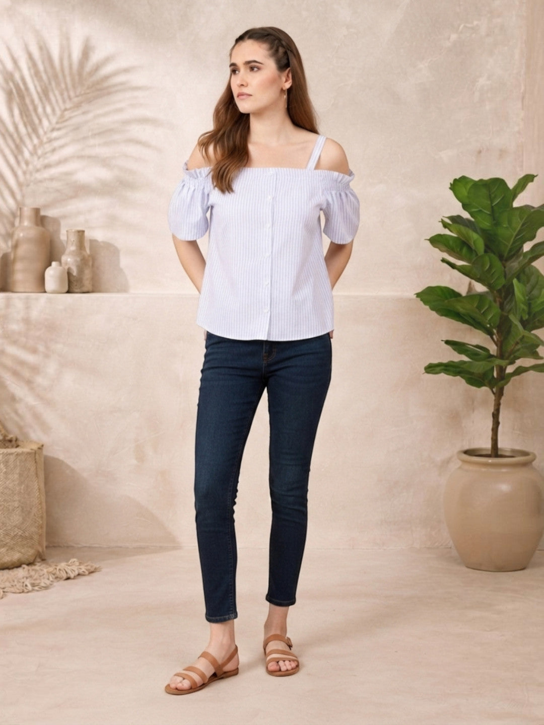 Striped off-shoulder blouse with puff sleeves, paired with skinny jeans and sandals for casual women's fashion