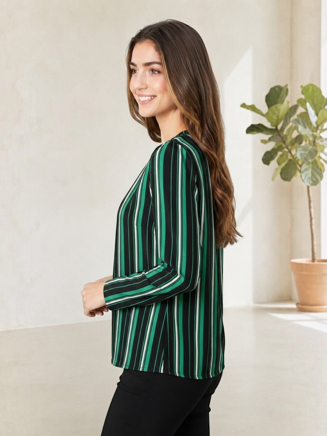 Woman in green and black striped long sleeve top, stylish plus size fashion