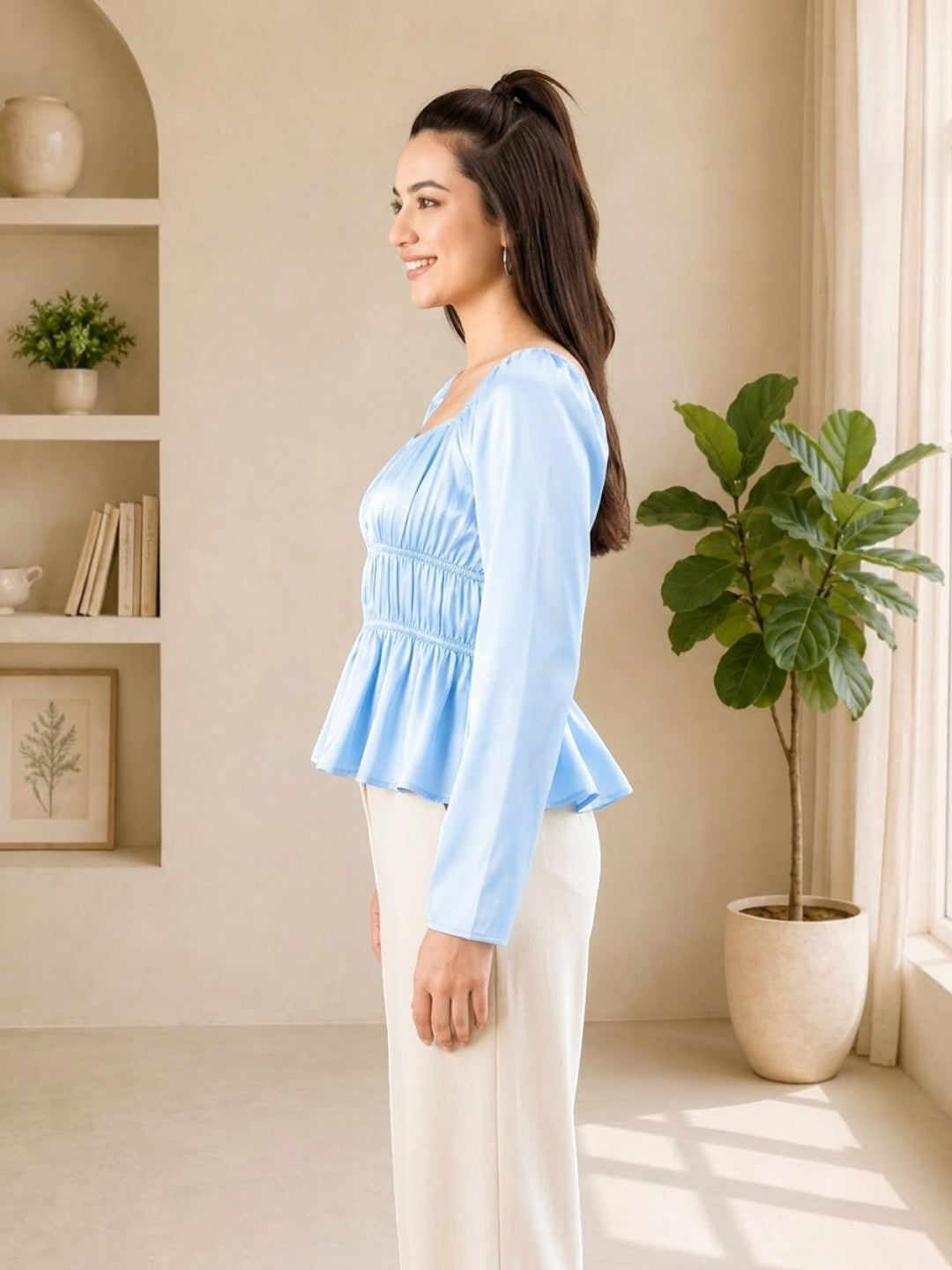Woman in light blue peplum top and white pants, stylish plus size fashion for everyday wear