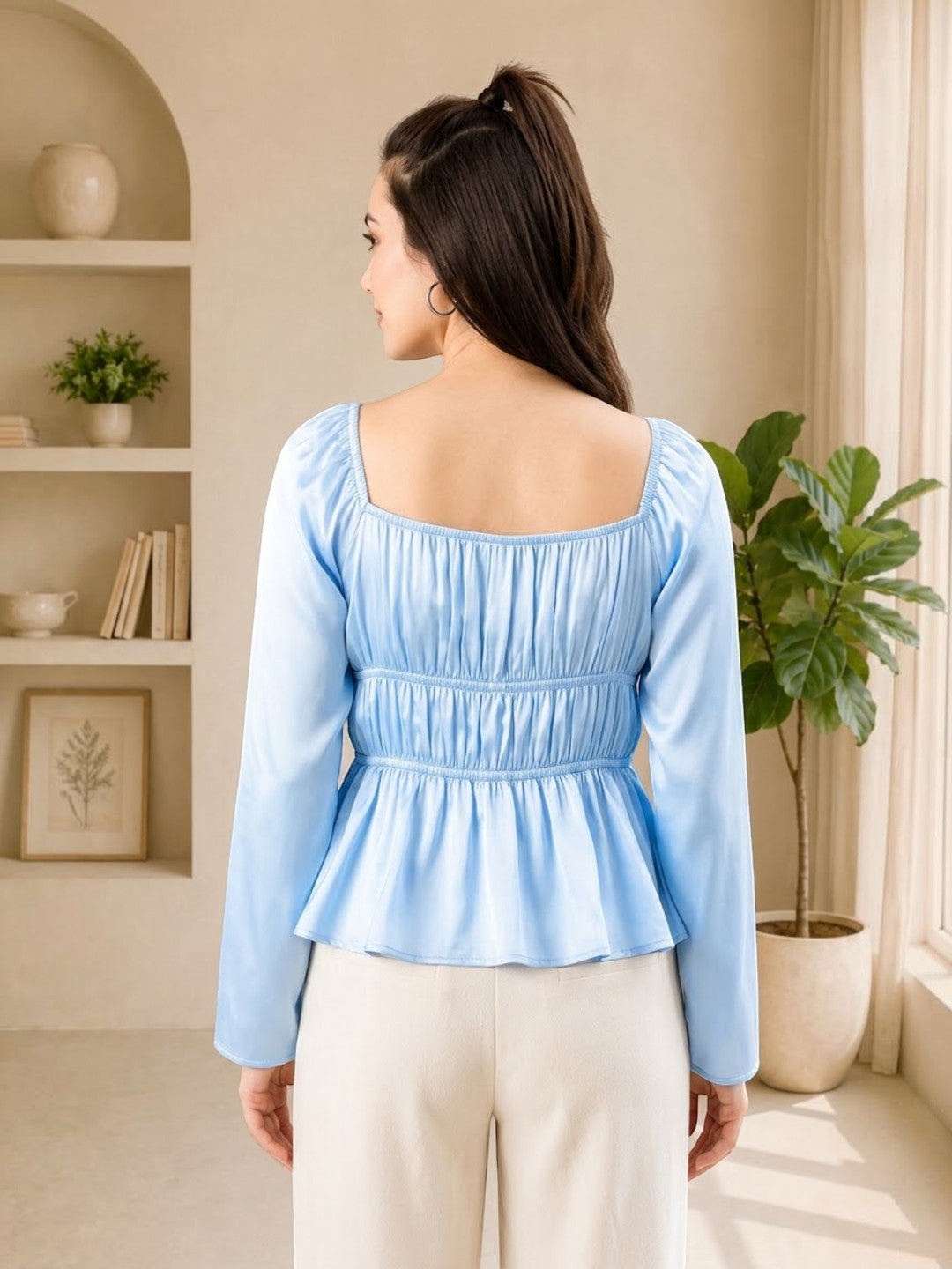 Light blue long sleeve peplum top with square neckline, back view, paired with cream pants for women's fashion