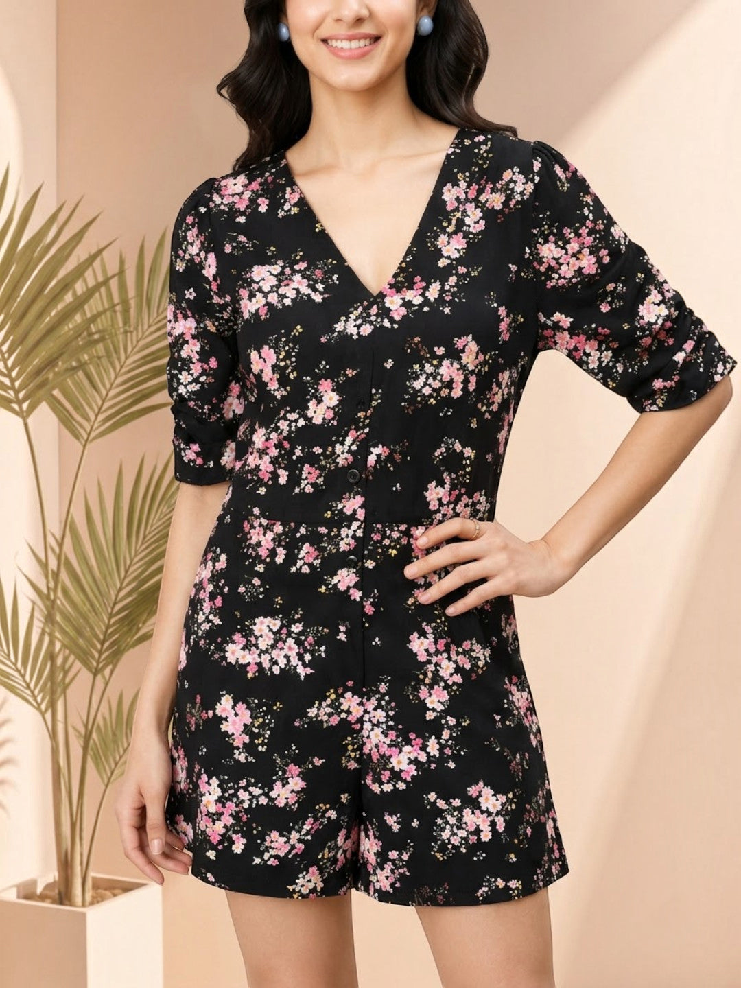 Black floral print romper with V-neck and button front, stylish women's fashion outfit