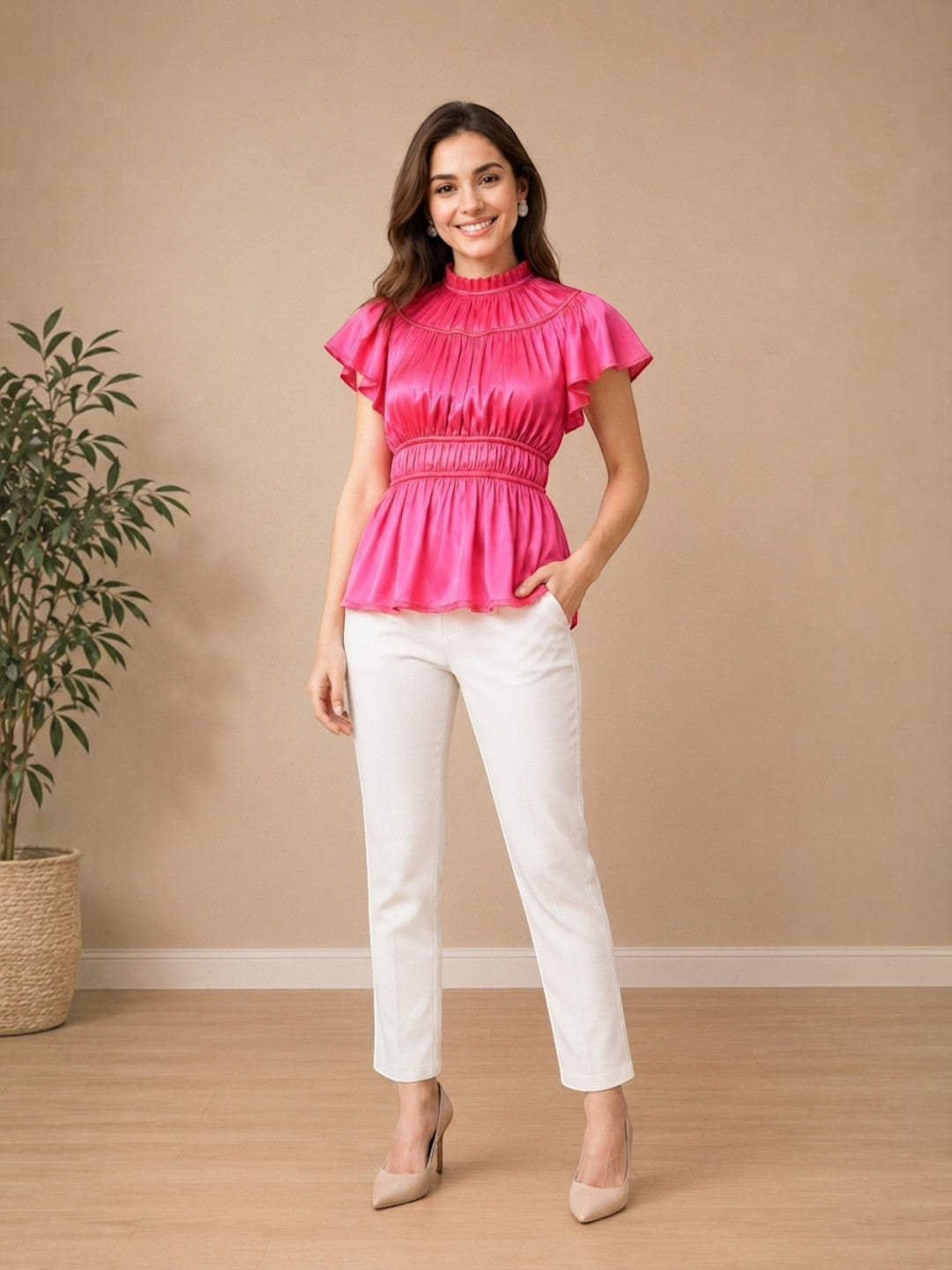 Woman in pink ruffled peplum top and white pants, stylish plus size fashion outfit