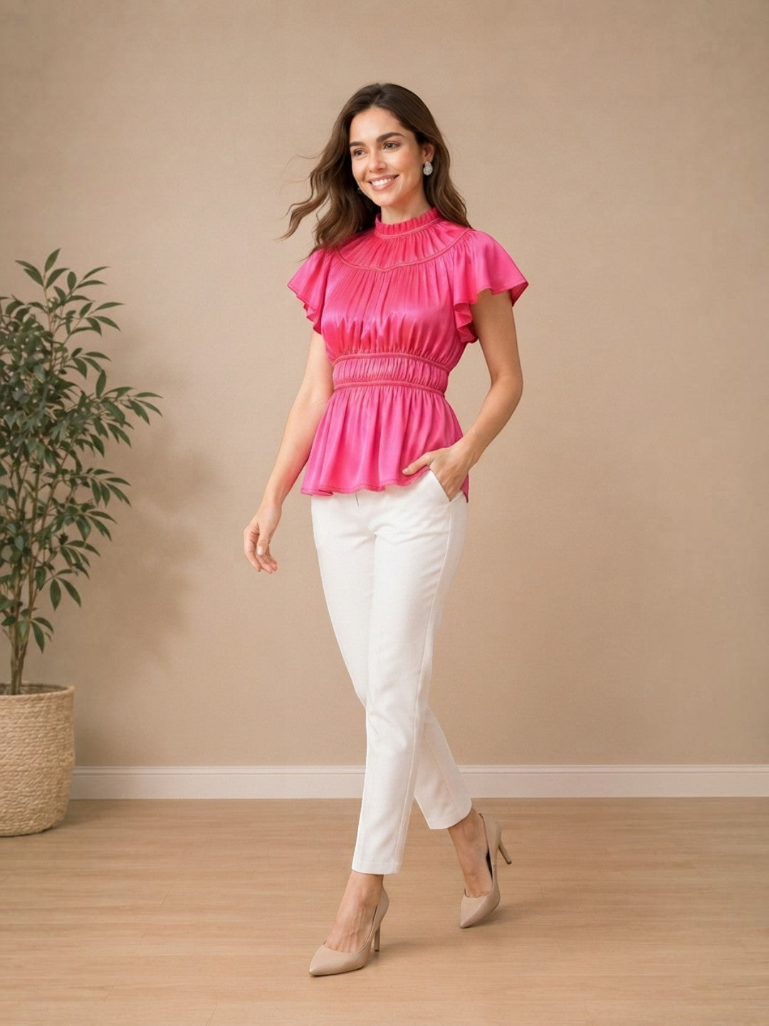 Woman in pink ruffled peplum top with white pants, stylish plus size fashion outfit