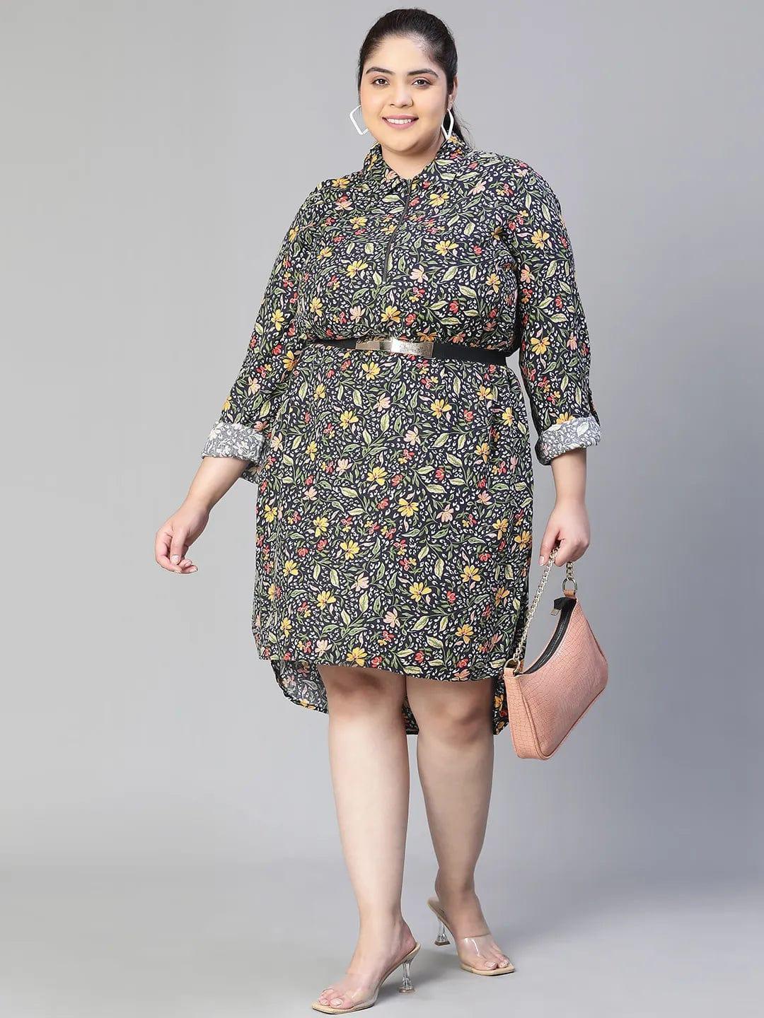 A woman wearing a black and white floral print dress with a high collar and long sleeves, smiling at the camera.