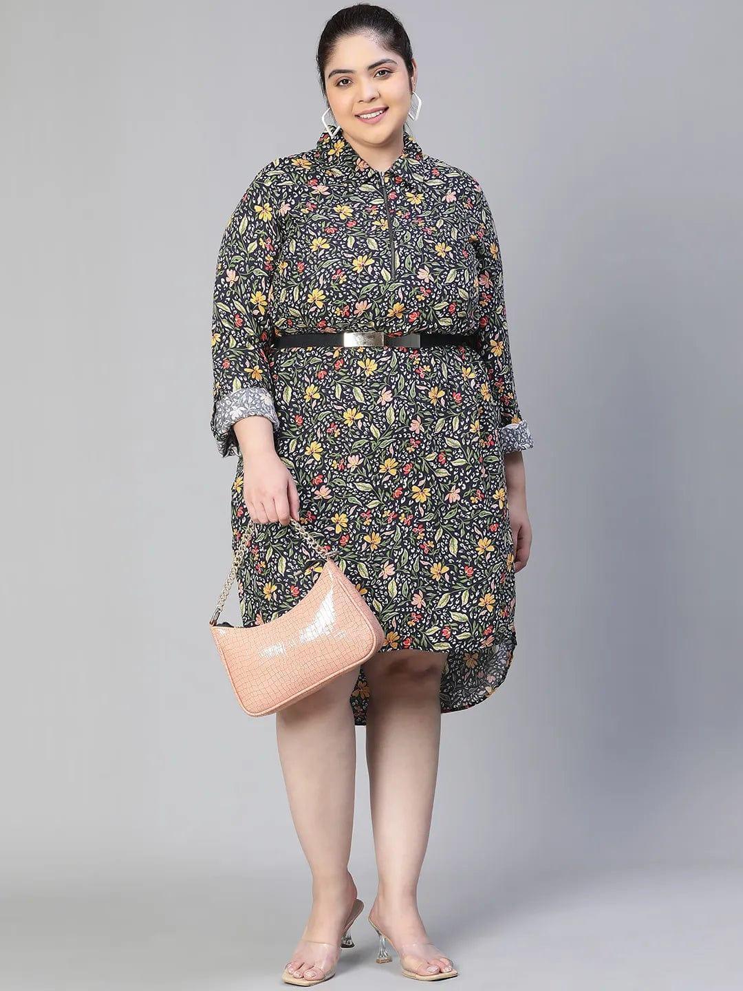 A woman wearing a black and white floral print dress with a high collar and long sleeves, smiling at the camera.
