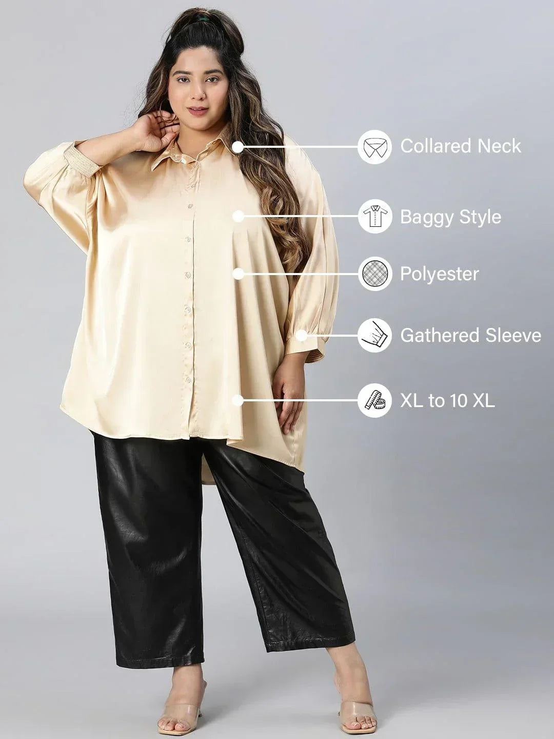 A woman with long brown hair wearing a cream-colored blouse and black pants, smiling at the camera.