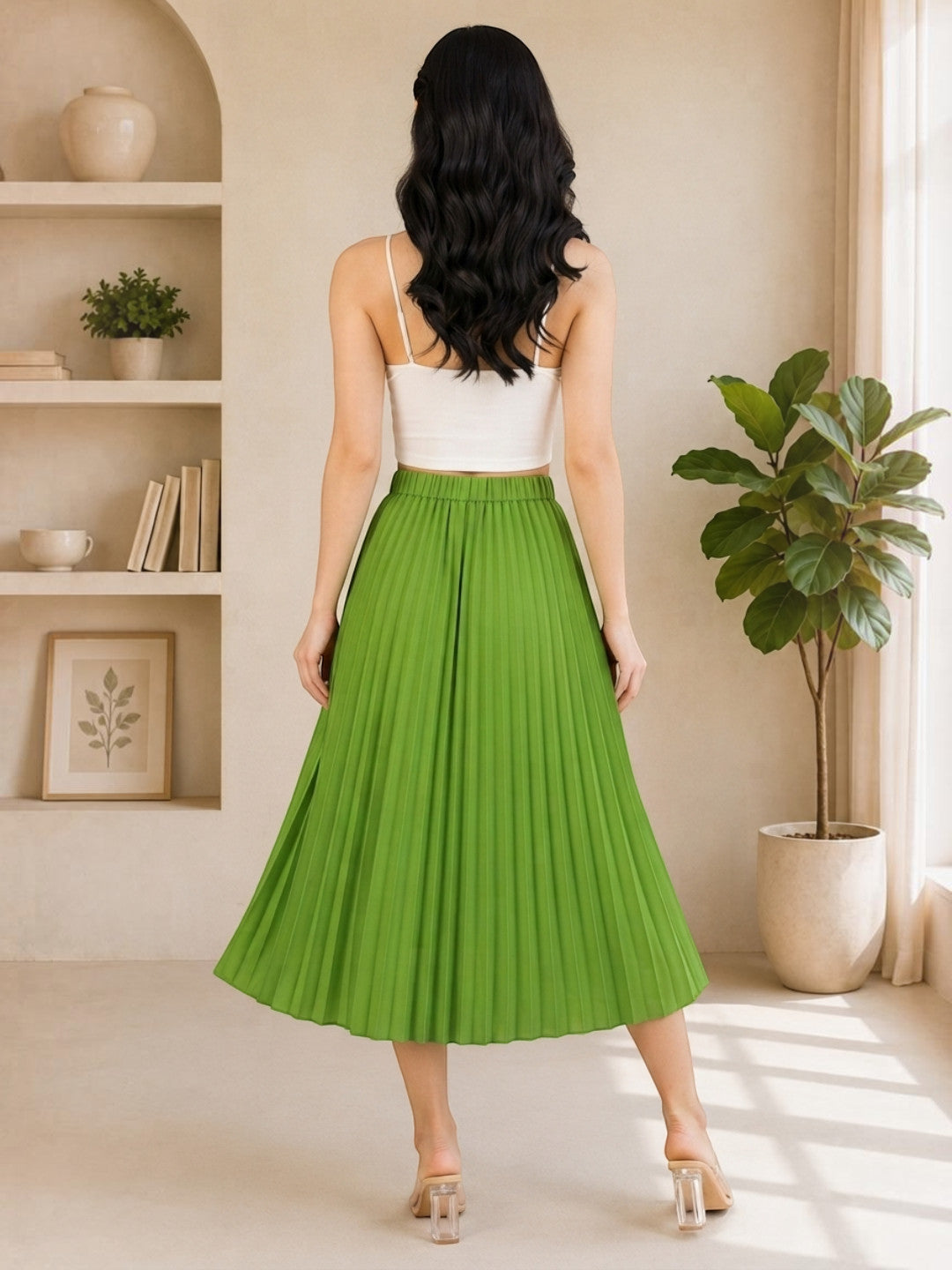 Woman wearing green pleated midi skirt with white crop top, stylish plus size fashion
