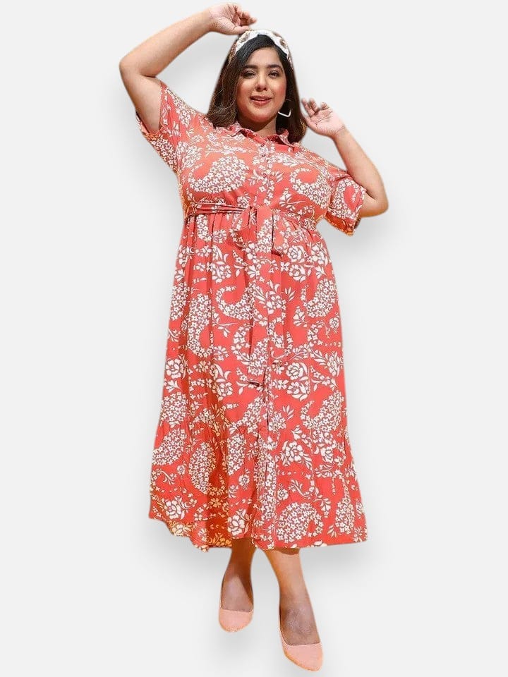 A woman wearing a red and white floral print dress with a high neckline and short sleeves, posing with her arms raised.
