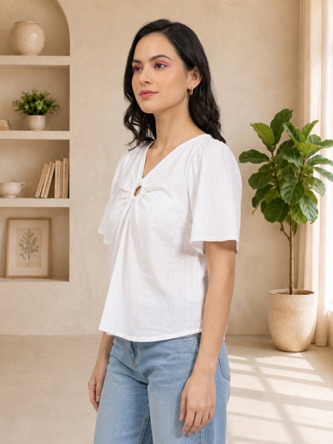 White V-neck tie-front top with short sleeves, styled with light blue jeans for casual women's fashion