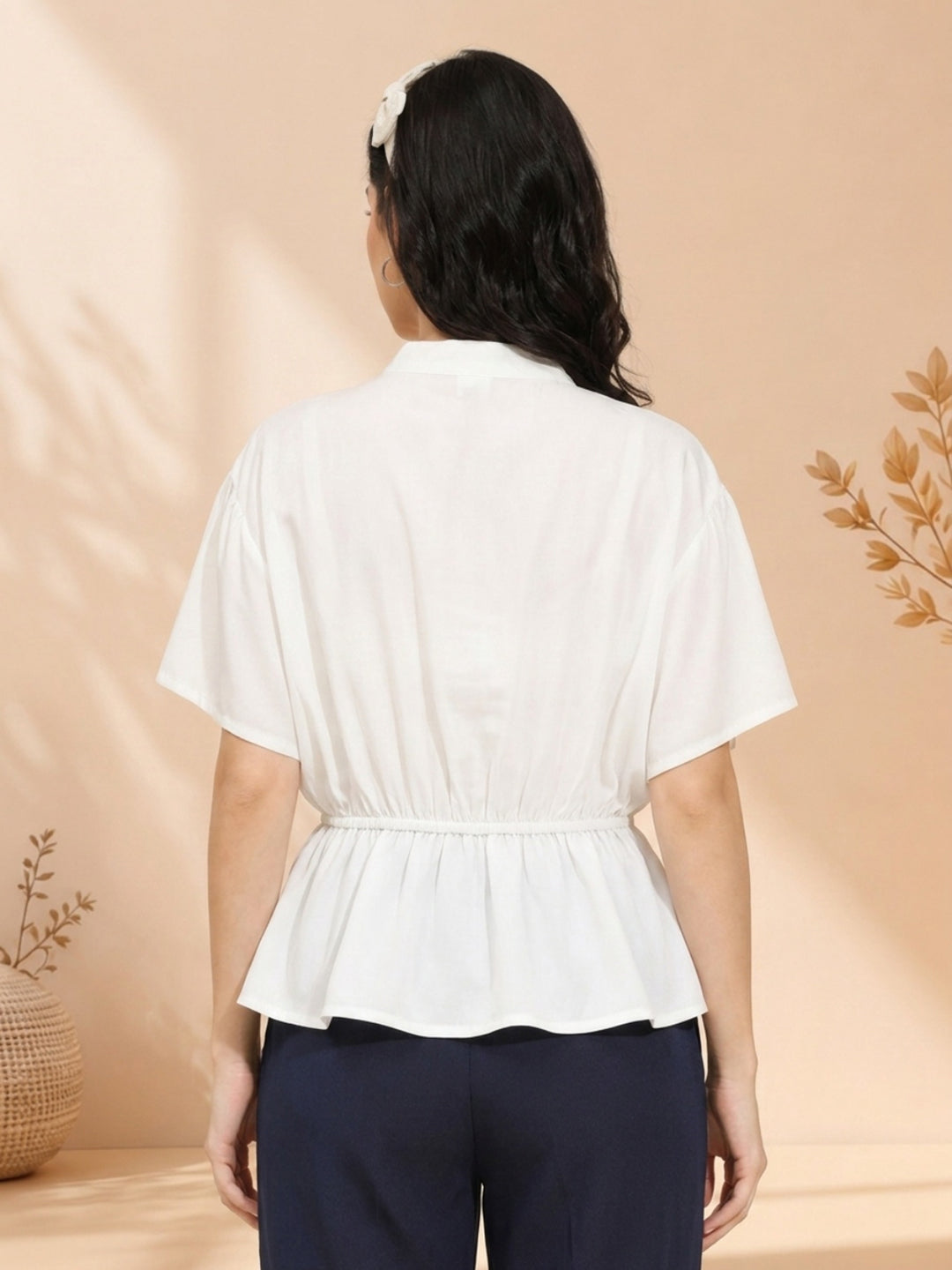 White peplum blouse with short sleeves, back view, paired with navy pants for women's fashion