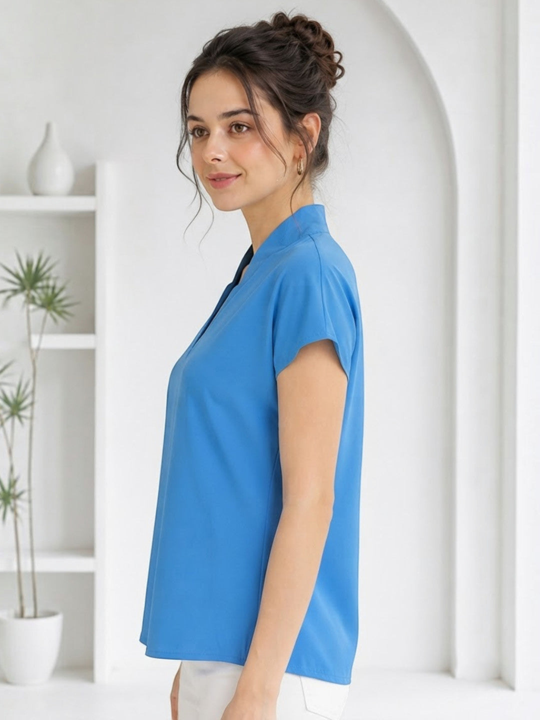 Woman modeling blue short sleeve top with V-neck, ideal for plus size & regular women's fashion