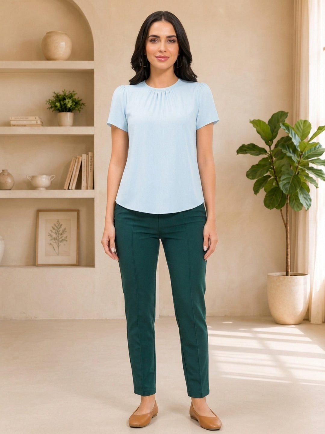 Light blue pleated top with dark green straight-leg pants, stylish women's fashion outfit