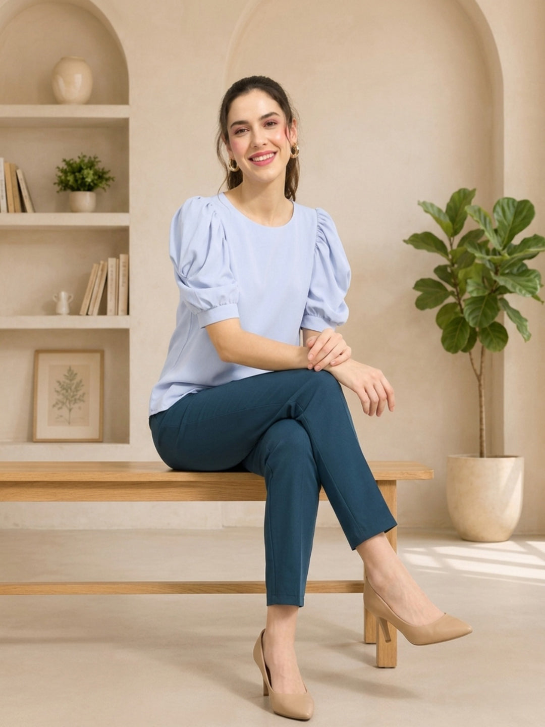 Woman in light blue puff sleeve top and teal cropped pants, stylish plus size fashion outfit