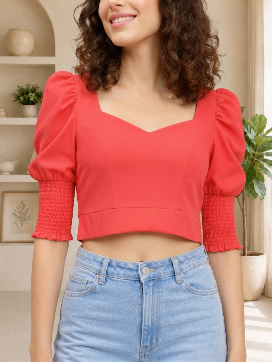 Red cropped top with puff sleeves and square neckline, paired with light wash jeans for trendy women's fashion
