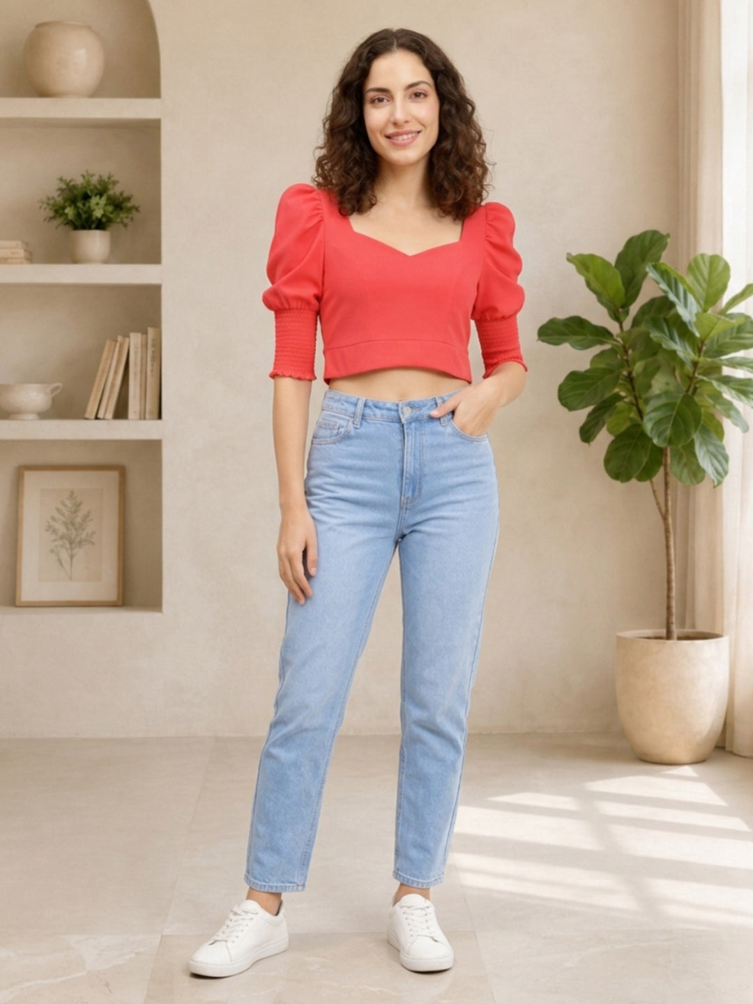Woman in red puff-sleeve crop top and light wash jeans, stylish plus size fashion outfit