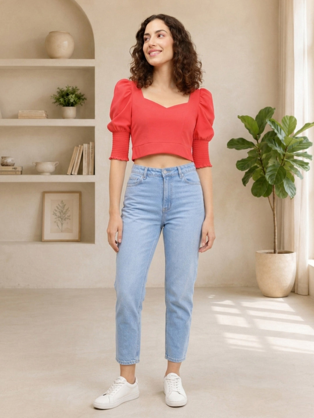 Woman in red puff sleeve crop top and light wash jeans, stylish casual outfit for women