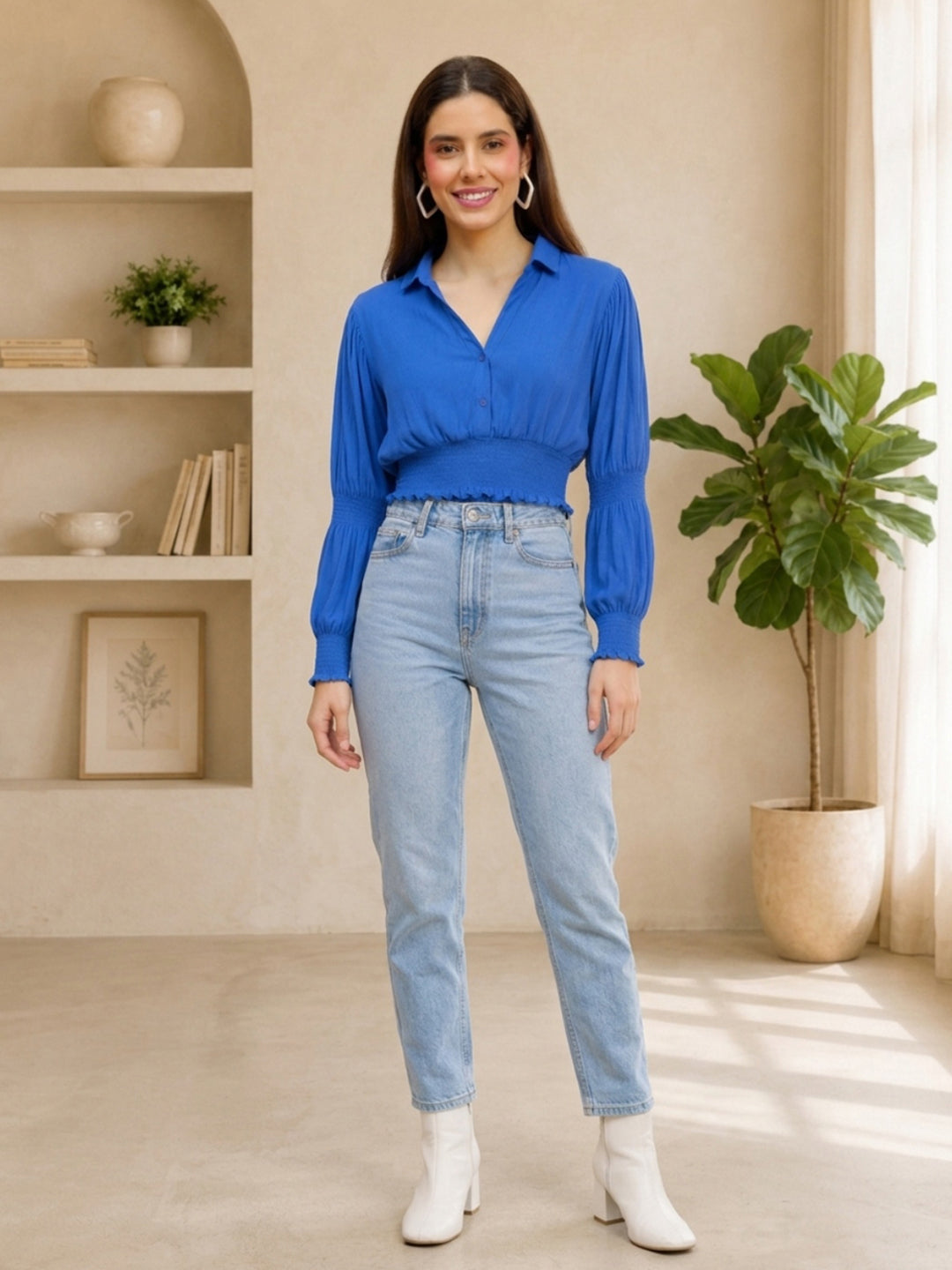 Woman in blue long sleeve blouse and light wash jeans, stylish plus size fashion outfit
