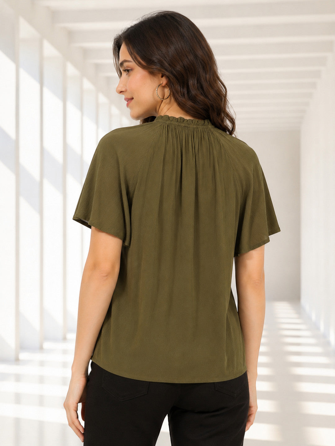 Olive green women's blouse with ruched neckline and short sleeves, styled with black pants for casual fashion.