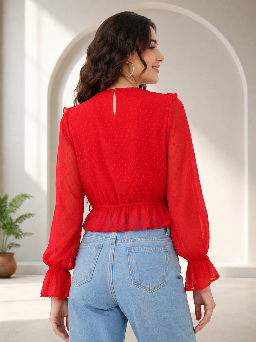 Red polka dot blouse with ruffled sleeves and peplum hem, paired with light blue jeans for women's fashion
