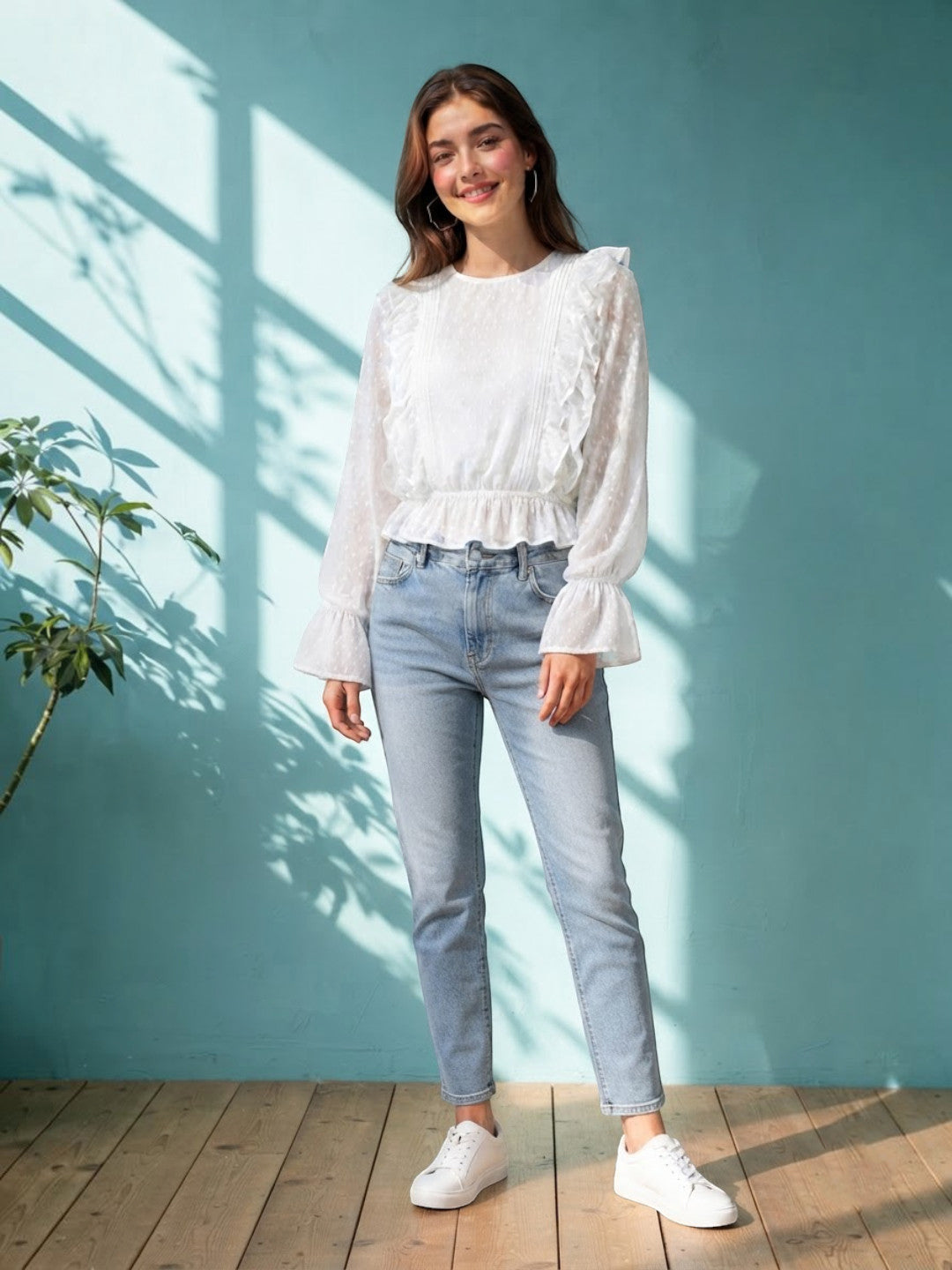 Woman in white ruffled blouse and light wash jeans, stylish plus size fashion outfit