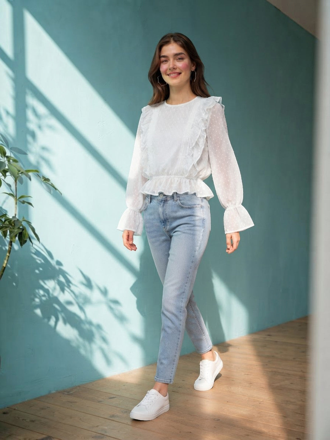 White ruffle blouse with sheer sleeves paired with light blue jeans and white sneakers