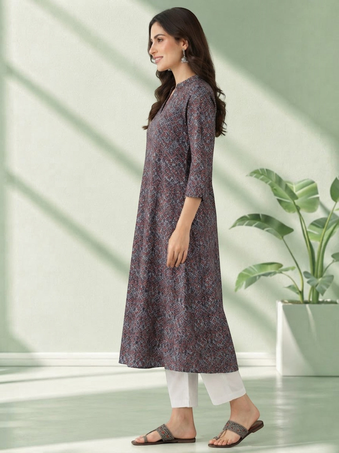 Woman in printed A-line kurta with white pants, stylish plus size fashion outfit