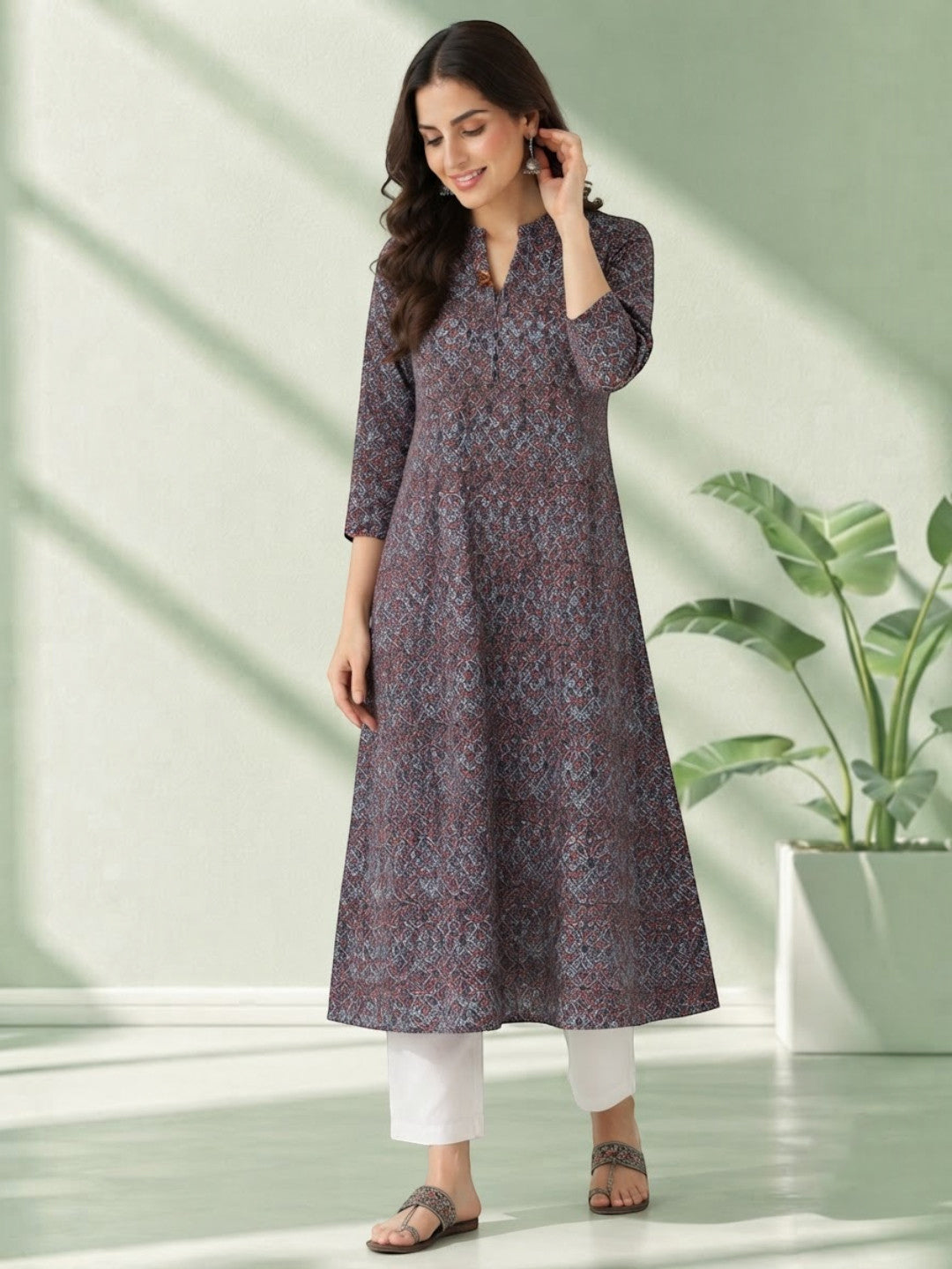 Woman wearing printed knee-length kurta with white pants, stylish plus size fashion outfit