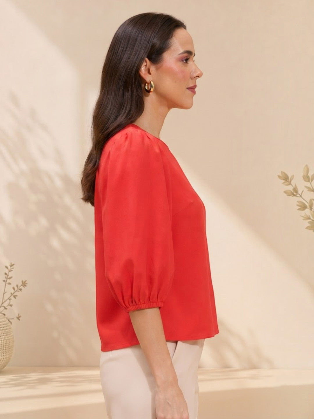Woman in red puff-sleeve blouse, stylish plus size fashion top, modern women's clothing