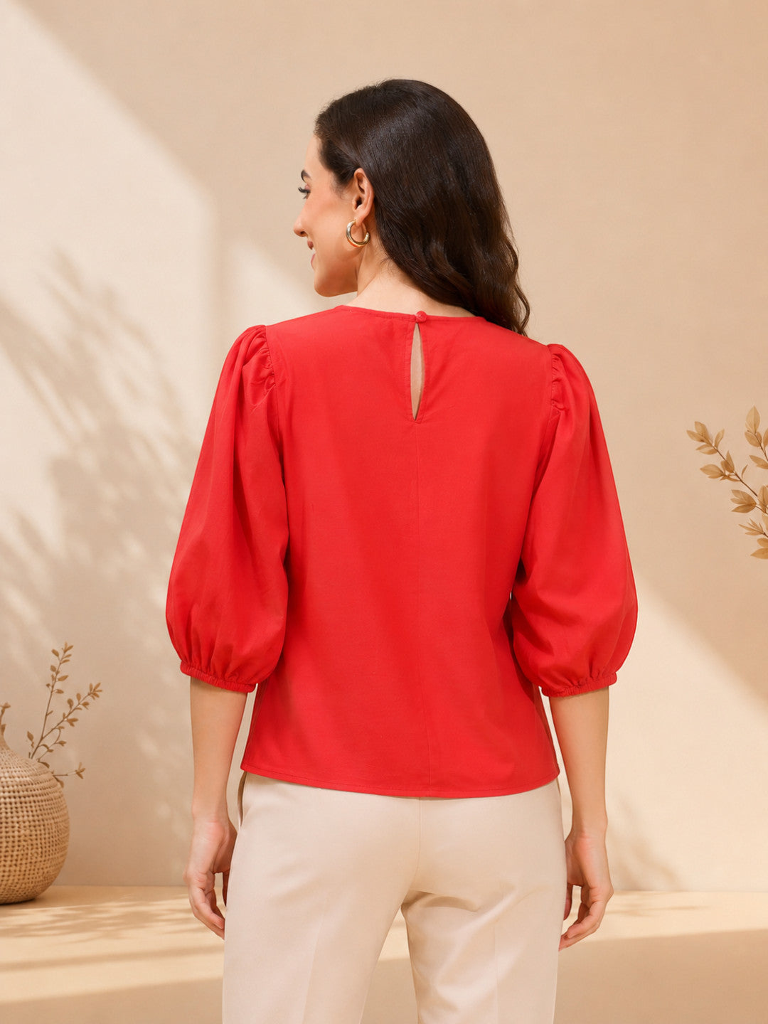 Red puff sleeve blouse with back keyhole detail, paired with cream pants for women's fashion
