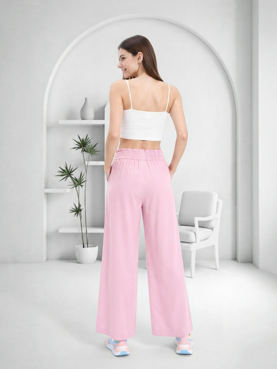 Woman wearing pink wide-leg pants and white crop top, stylish plus size fashion outfit